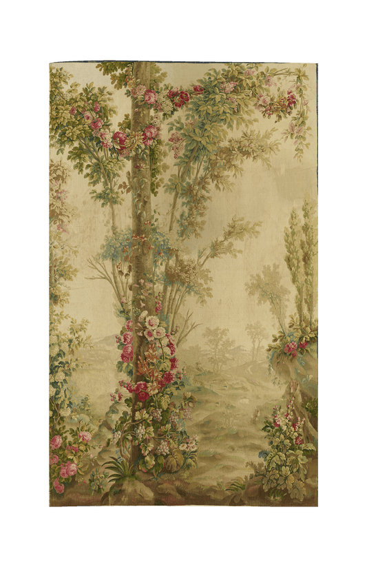 This elegant French Verdure tapestry showcases a lush woodland scene adorned with intricate floral details, capturing the serene beauty of nature. The tapestry features tall, leafy trees intertwined with blooming flowers in soft hues of pink, green, and cream. 