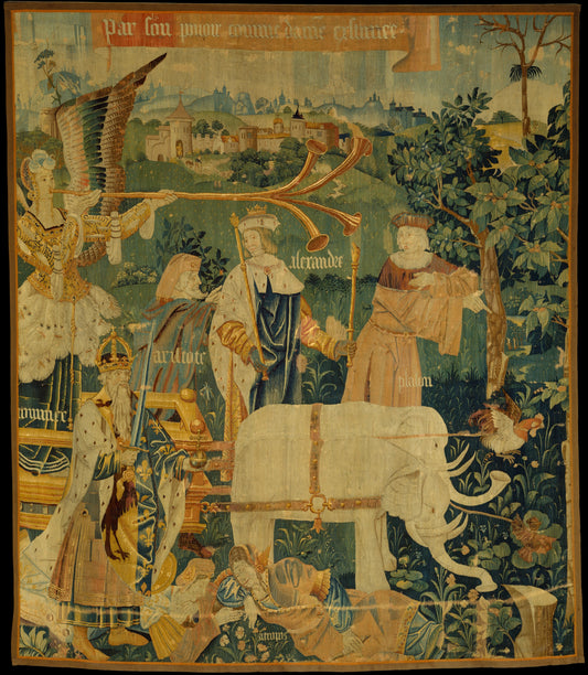 Medieval-style tapestry reproduction depicting a vibrant Gothic scene with elaborately dressed noble figures, medieval architecture, and intricate floral borders. The tapestry includes text in Old French, showcasing storytelling elements amidst rich details and vibrant colors.