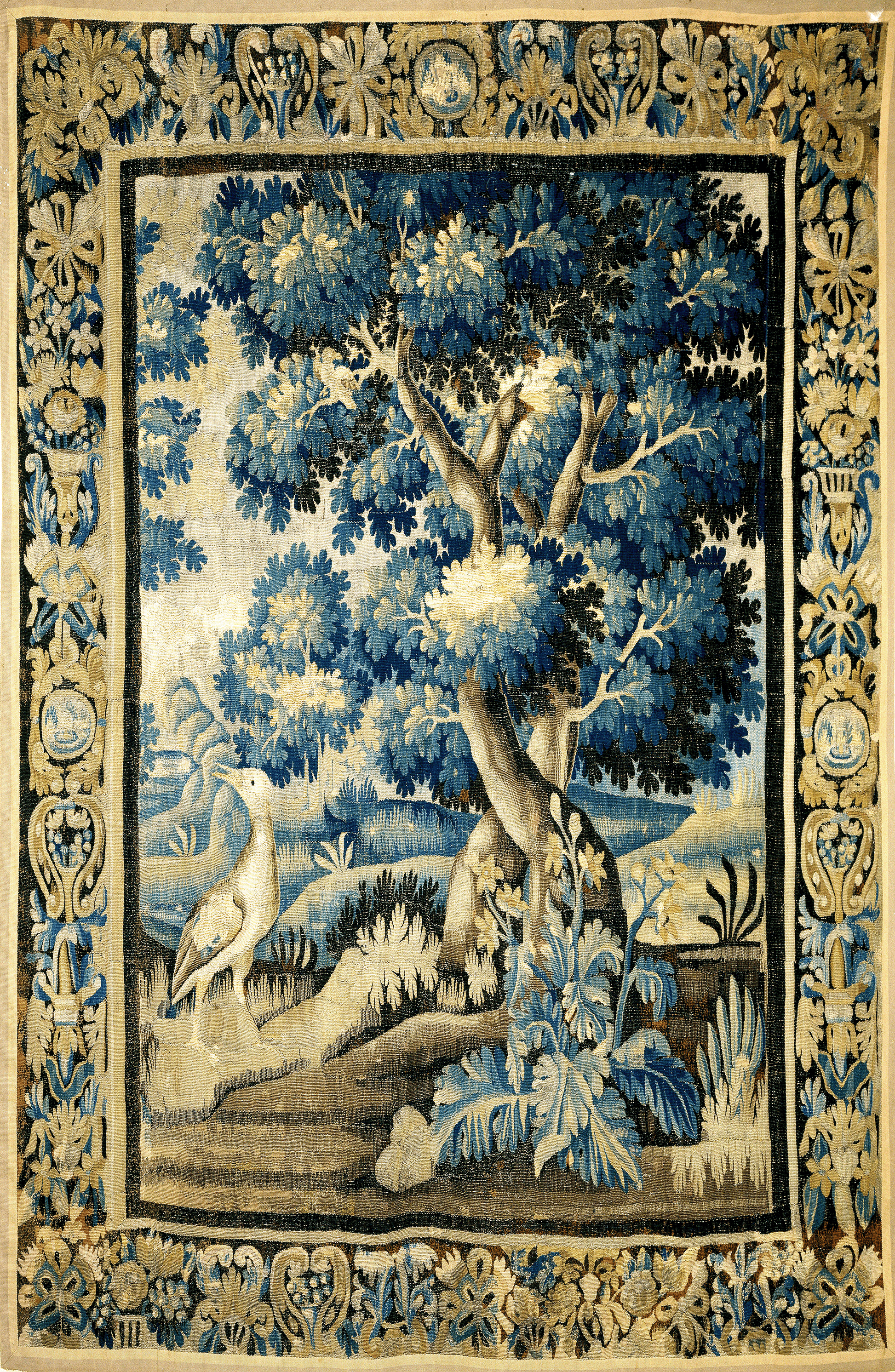 A richly detailed 17th-century verdure tapestry, depicting a lush forest scene with towering trees, vibrant foliage, and delicate wildlife. Sunlight filters through the dense canopy, casting dappled shadows on the forest floor. The tapestry exudes a sense of tranquility and natural beauty, inviting viewers to immerse themselves in its timeless allure.